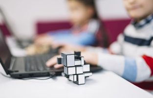 cube-puzzle-front-girl-using-laptop-white-desk